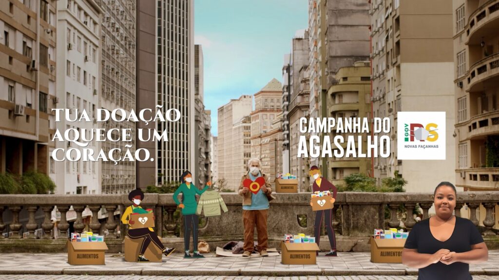 Intérprete de libras no canto inferior esquerdo da imagem. Imagem é sobre a campanha do agasalho do Rio grande do Sul.